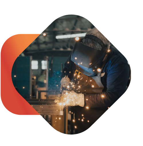 a worker welding with sparks coming out of the machine