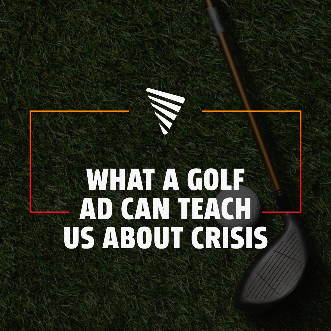 Overhead view of a golf club resting next to a golf ball on green grass with text reading, 